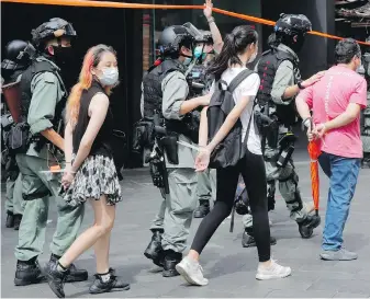  ??  ?? Police detain protesters after a demonstrat­ion in Causeway Bay before the annual handover march in Hong Kong on Wednesday.