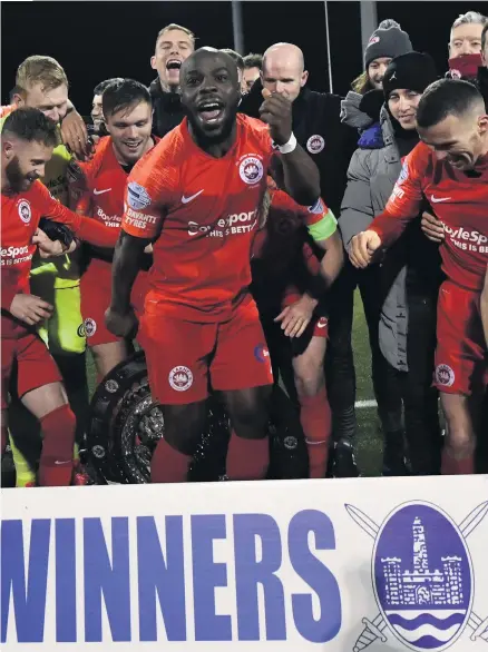  ?? COLM LENAGHAN/ PACEMAKER ?? Glory hunters: Larne players celebrate their County Antrim Shield success