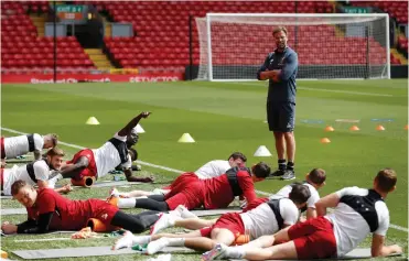  ?? Picture: CARL RECINE, REUTERS ?? IT CAN BE PAINFUL ON THE SIDELINES, HEY? Jurgen Klopp watches over his team during a recovery session at Anfield yesterday.