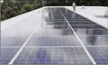  ?? BOB ANDRES / ROBERT.ANDRES@AJC.COM ?? Scott Starowicz, chief financial officer, walks past solar panels at SAE, on track to become the state’s first elementary school to operate with 100% solar energy.