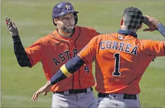  ?? HOUSTON’S GEORGE SPRINGER Ashley Landis Associated Press ?? is greeted by Carlos Correa after hitting a two- run homer in the third inning of the Astros’ 5- 2 win at Dodger Stadium. Springer added a solo shot in the f if th.