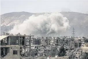  ?? AFP ?? Smoke billows following a reported air strike in the rebel-held parts of the Jobar district, on the eastern outskirts of the Syrian capital Damascus, on Sunday. Heavy clashes rocked eastern districts of the city as rebels and jihadists tried to fight...