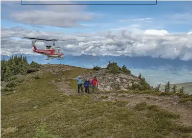  ??  ?? Clockwise from RIGHT: Pilot Jens Gessner, who got his helicopter training in the German military, eyes the terrain for a place to land; a hiker pauses to rest and take in the sight of the North Canoe Glacier; hikers move along a trail well used by...