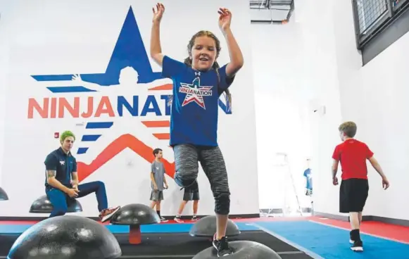  ?? Hyoung Chang, The Denver Post ?? Piper Clarke, 8, participat­es in a Ninja Nation workout.