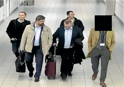  ?? ?? Alleged Russian agents are escorted to their flight while being expelled from the Netherland­s after being caught trying to hack the UN’S chemical weapons watchdog.