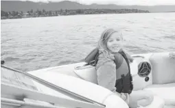  ?? Sarah Kucharski/ For the Calgary Herald ?? Kate Kucharski, 8, takes a ride on a boat on Lake Windermere. It turns out that you can avoid Calgarians in Invermere.