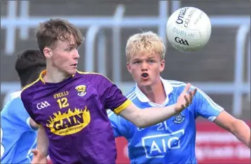  ??  ?? Wexford’s Lee Nolan tries to keep the ball away from Euan Farquharso­n on Dublin.