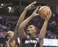  ?? SUE OGROCKI / AP FILE ?? Miami Heat forward Chris Bosh shoots in front of Oklahoma City Thunder forward Kevin Durant in the first quarter of an NBA game in Oklahoma City on Jan 17.