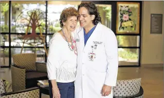  ?? RICHARD GRAULICH / THE PALM BEACH POST ?? “There was no rushing, they answered all my questions and everything was explained to me in detail,” said patient Mary Dailey, here with Dr. L Raul Arroyo, of the new Comprehens­ive Breast Care Program at the Foshay Cancer Center in Jupiter Medical...