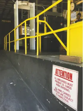  ?? Andrew Ross / The Chronicle ?? A security guard watches over a metal detector at an employee entrance of the UPS distributi­on where Jimmy Chanh Lam shot and killed three co-workers.