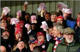  ??  ?? FUNNY
MONEY: Gleeful Gloucester fans revel in Saracens’ misery with fake bank notes yesterday