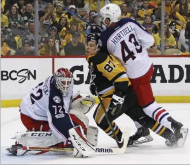  ?? GENE J. PUSKAR — THE ASSOCIATED PRESS ?? The Penguins’ Sidney Crosby (87) is hit by the Blue Jackets’ Scott Hartnell (43) as he gets off a shot in front of goalie Sergei Bobrovsky (72) during the second period in Game 2 of an NHL first-round hockey playoff series in Pittsburgh.