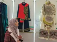  ?? ?? A visitor looks at creations displayed during the annual exhibition on fashion and clothes designed by young Iranian designers.