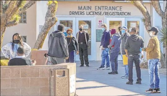  ?? L.E. Baskow Las Vegas Review-Journal @Left_Eye_Images ?? A crowd waits Saturday outside the Nevada Department of Motor Vehicles branch on West Flamingo Road.