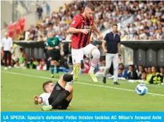  ?? — AFP ?? LA SPEZIA: Spezia’s defender Petko Hristov tackles AC Milan’s forward Ante Rebic during the Italian Serie A football match between Spezia and AC Milan on Saturday at the Alberto-Picco stadium in La Spezia.