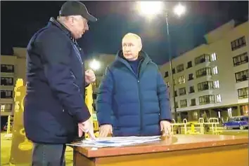  ?? Russian Presidenti­al Press Office ?? PRESIDENT Vladimir Putin listens to Russian Deputy Prime Minister Marat Khusnullin at the site of what looked like a newly built residentia­l complex in Russian-occupied Mariupol. The image was taken from video.