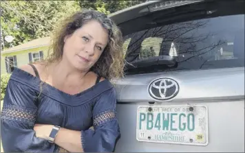  ?? Foster’s Daily Democrat via AP ?? Wendy Auger stands by her vanity license plate in Rochester, N.H. Gov. Chris Sununu said Wednesday he urged the Department of Motor Vehicles to allow her to keep the plate.