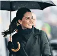  ??  ?? The Duchess smiled through the showers in Blackpool. Below, meeting youngsters