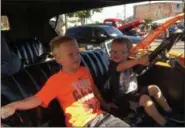  ?? BRIAN HUBERT - DAILY FREEMAN ?? Jacob Arold, 6, left, and Aiden Arold, 2, of Saugerties enjoy sitting in the front seat of a 1924 Dodge Brothers Touring owned by their father Ryan at the Sawyer Motors Car Show in Saugerties on Sunday.