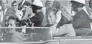  ?? JIM ALTGENS, / THE ASSOCIATED PRESS ?? President John F. Kennedy waves from his car on Nov. 22, 1963, in Dallas just before his assassinat­ion.