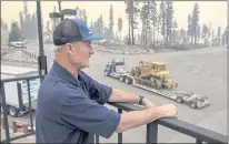  ??  ?? Sierra-at-Tahoe general manager John Rice watches as bulldozers arrive to stage at the ski resort on Saturday to fight the raging Caldor Fire. “I’ll take whatever I can get,” Rice said of the efforts.
