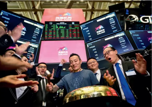  ??  ?? Peng Ou (center), founder of Sunlands Online Education Group, rings a ceremonial bell during the company’s initial public offering (IPO) on the floor of the New York Stock Exchange in the United States. by Michael Nagle/bloomberg via Getty Images/ VCG