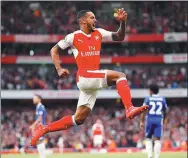  ?? JOHN SIBLEY / REUTERS ?? Arsenal's Theo Walcott celebrates scoring his team’s second goal against Chelsea. Arsenal won 3-0.