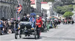  ??  ?? Royal chariot . . . Gordon and Wendy Pringle, of Oamaru, escort Julie Clark, as Queen Victoria, in their replica 1901 Oldsmobile. Holding flags behind are Graeme Clark and Peter Benson.