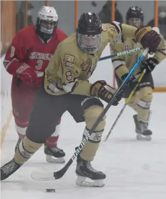  ?? JiM MicHAuD / BoSTon HErALD ?? BREAKING AWAY: BC High’s Neil Murphy handles the puck during the Eagles’ 7-1 win over Catholic Memorial yesterday.