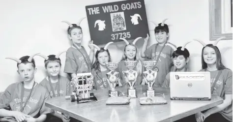  ?? [VERONICA REINER / THE OBSERVER] ?? Eight kids comprised the St. Clements Wild Goats robotics team, posing in front of their robot nicknamed “Billy the Goat.” The group were friends years before getting into robotics. Team members include Tyler MacDonald, Hudson Jantzi, Connor Jantzi, Kayia MacDonald, Brooklyn Alpaugh, Connor Cheng, Tanner Cheng and Beth Alpaugh.