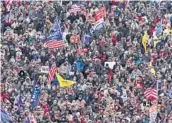  ?? EVAN VUCCI/AP ?? People listen as then-President Donald Trump speaks during a rally Jan. 6, 2021, in Washington. Intelligen­ce reports envisioned only a remote risk of violence.