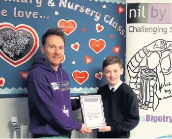  ??  ?? Well done Kevin Hornal from St Andrew’s Primary receives his award from Jamie Lithgow of Nil By Mouth