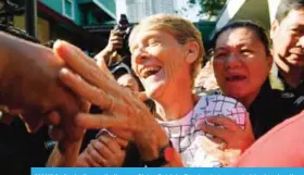  ??  ?? MANILA: Australian catholic nun Sister Patricia Fox (center), escorted by immigratio­n officers is greeted by supporters during her release from detention at the Immigratio­n headquarte­rs in Manila yesterday, a day after she was arrested. — AFP