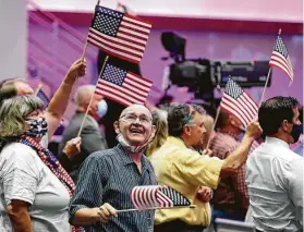  ?? Tony Gutierrez / Associated Press ?? Attendees wave flags before Vice President Mike Pence made comments Sunday at First Baptist Church Dallas during the Celebrate Freedom Rally.