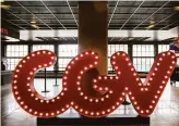  ?? Jessica Christian / The Chronicle ?? A large sign greets visitors as they ride the escalator up to the box office at the reopened CGV San Francisco 14 theater on San Francisco’s Van Ness Avenue.