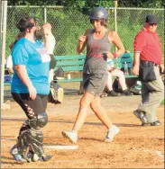  ?? Peter Wallace / For Hearst Connecticu­t Media ?? Stephanie Maxwell scores for her Sawyer’s Girls team in the Torrington Parks and Recreation Softball League as Torrington Downtown Partners/USA Hauling catcher Linda Lafferty-Cerruto waits for another chance Thursday evening at Joe Ruwet Park.