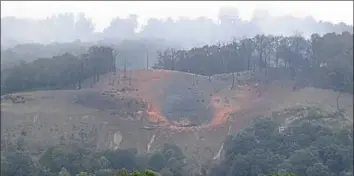  ?? Darrell Sapp/Post-Gazette photos ?? A view of the burned-out hillside below Ivy Lane caused by a gas line explosion Monday in Beaver County.