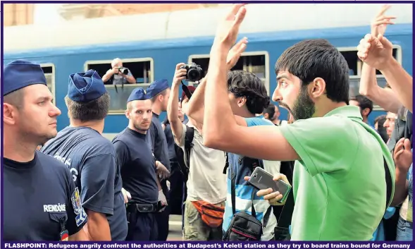  ?? Picture: GETTY ?? FLASHPOINT: Refugees angrily confront the authoritie­s at Budapest’s Keleti station as they try to board trains bound for Germany