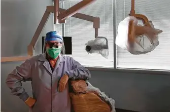  ?? Charles Rex Arbogast / Associated Press ?? Dr. Terri Tiersky wears full personal protective equipment — double mask, face shield, gown and gloves — at her dentist office in Skokie, Ill., on Friday.