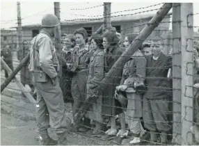  ?? COLLECTION OF THE FLORIDA HOLOCAUST MUSEUM, COURTESY OF HELEN B. MICHELL ?? A U.S. soldier greets liberated prisoners at Mauthausen concentrat­ion camp in May 1945.