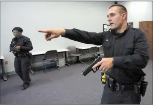  ?? Arkansas Democrat-Gazette/THOMAS METTHE ?? Little Rock police cadets Cameron Vail (right) and Eboney Warren run a simulation of an investigat­ion on Friday at the Little Rock Police Training Academy. The department reported a decrease in the number of use-of-force incidents last year.