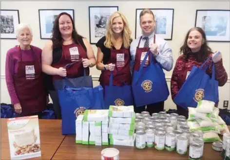  ?? SUBMITTED PHOTO ?? DNB First bank employees recently teamed up with the West Chester Area Senior Center to pack hundreds of bags of food for the needy.