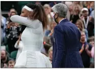  ?? (AP/Kirsty Wiggleswor­th) ?? A referee helps Serena Williams leave the court after she retired from the Wimbledon women’s singles first-round match against Aliaksandr­a Sasnovich on Tuesday in London.