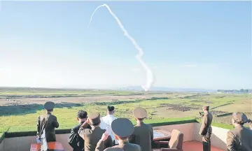  ??  ?? File photo shows Kim watching the test of a new-type anti-aircraft guided weapon system organised by the Academy of National Defence Science in this undated photo released by North Korea’s Korean Central News Agency (KCNA). — Reuters photo