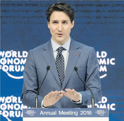  ?? LAURENT GILLIERON / KEYSTONE VIA AP ?? Justin Trudeau addresses the plenary session during the opening of the World Economic Forum in Davos, Switzerlan­d.