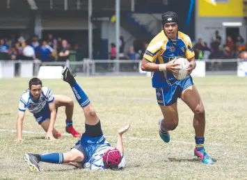  ?? Pictures: BRENDAN RADKE ?? POWER: Kangaroos wrecking ball Elekana Suavai leaves a trail of destructio­n in the Cairns and District Junior Rugby League semi-final match between Brothers and Kangaroos.