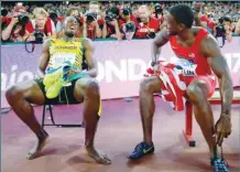  ?? — Reuters ?? Usain Bolt of Jamaica (L) sits on a bench with Justin Gatlin of US after the men’s 200 metres final during the 15th IAAF World Championsh­ips at the National Stadium in Beijing, China on August 27, 2015. Bolt finished in first place and Gatlin in second place.