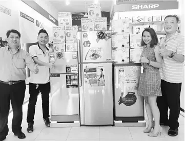  ??  ?? (From left) Kiew, Lo, Tay and Hiew standing next to the prizes waiting to be claimed, from a lucky draw held in conjunctio­n with the Sharp Concept Store’s grand opening in Matang.