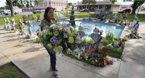  ?? AP ?? Veronica Mata visits a memorial for her daughter, Tess, and the other victims of last year’s mass shooting in Uvalde, Texas
