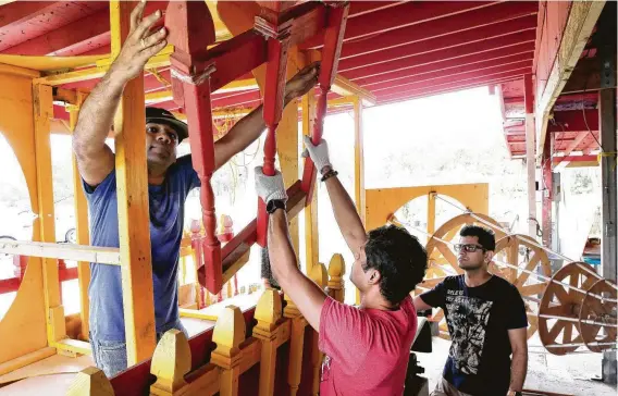  ?? Photos by Michael Wyke / Contributo­r ?? Members of the Orissa Culture Center unpack the parts of a deity chariot from storage. When assembled and refurbishe­d, the float-sized display will serve as a focal point in Saturday’s 12th annual Houston Ratha Yatra.